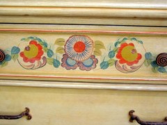 Close-up of hand painted floral decoration on drawer front.